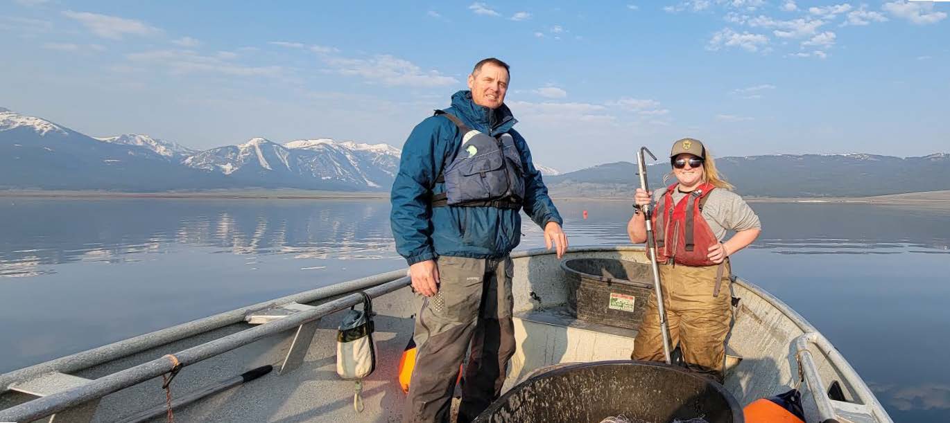 Two people standing on a gill net boat on Henrys Lake