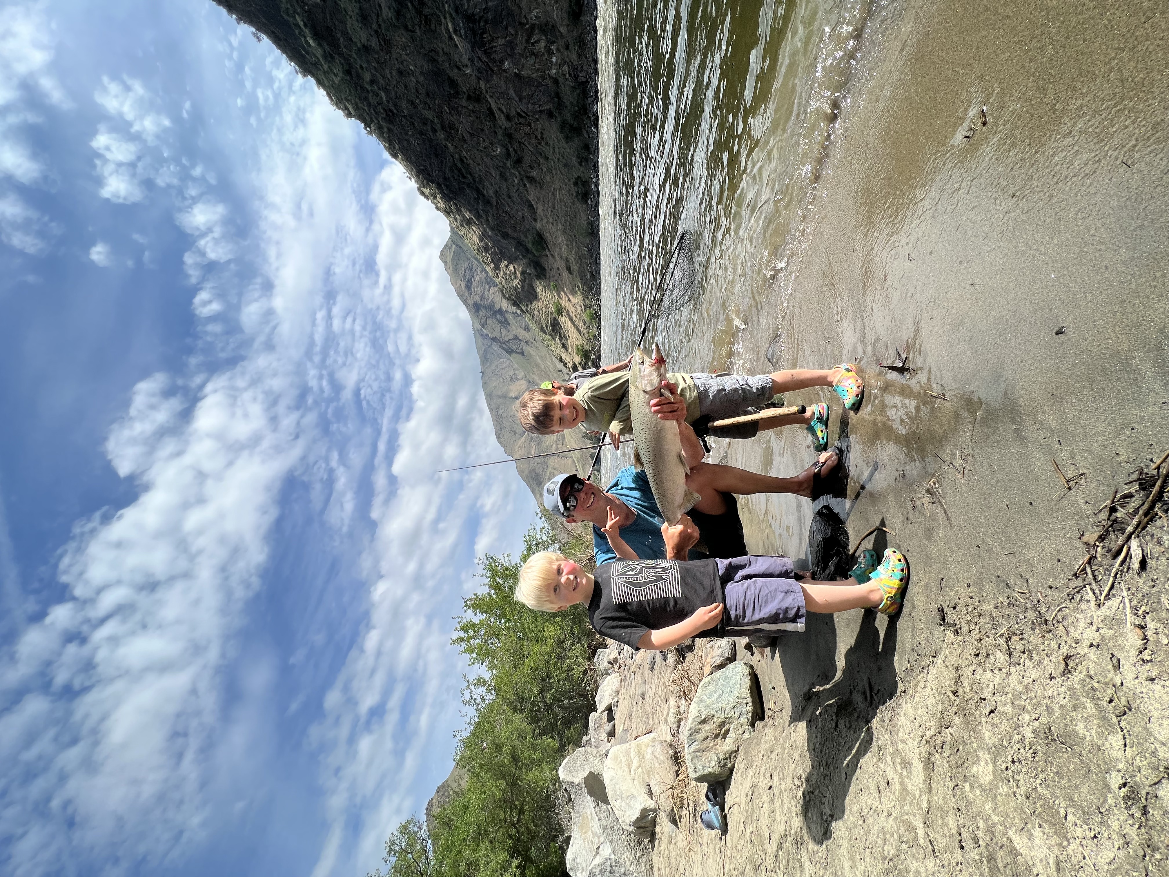 Fisheries manager Jordan Messner poses with his children and a Chinook salmon caught near Riggins.