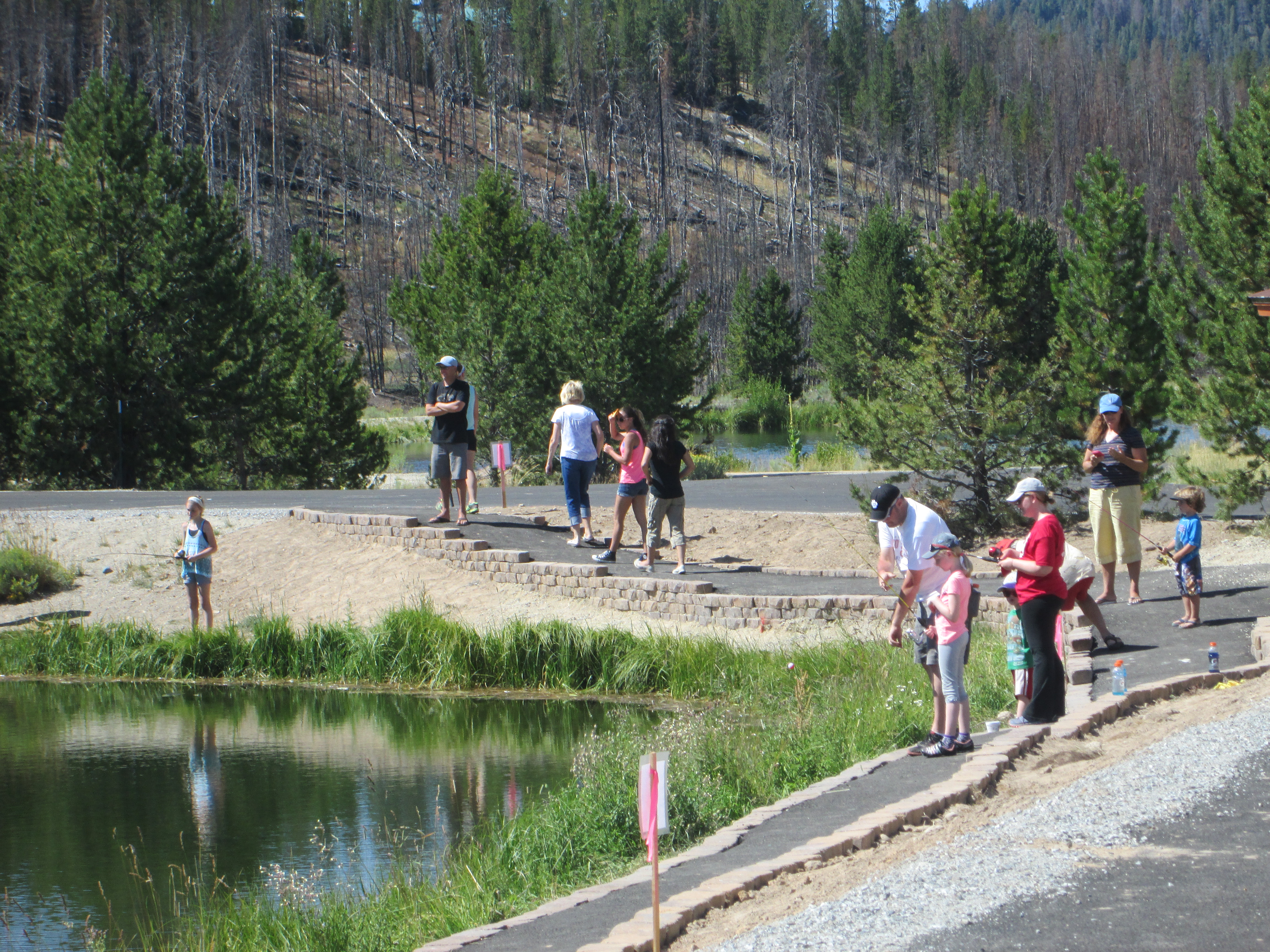 Sawtooth Fish Hatchery access kids pond adults and kids fishing wide shot July 2015