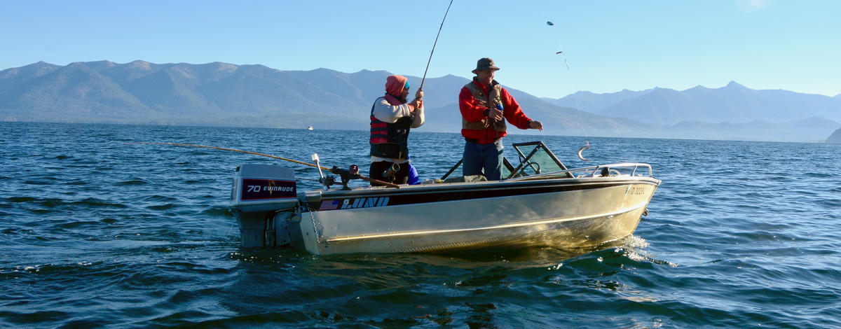 family fishing in a boat for kokanee on Lake Pend Oreille fish on September 2015 medium shot