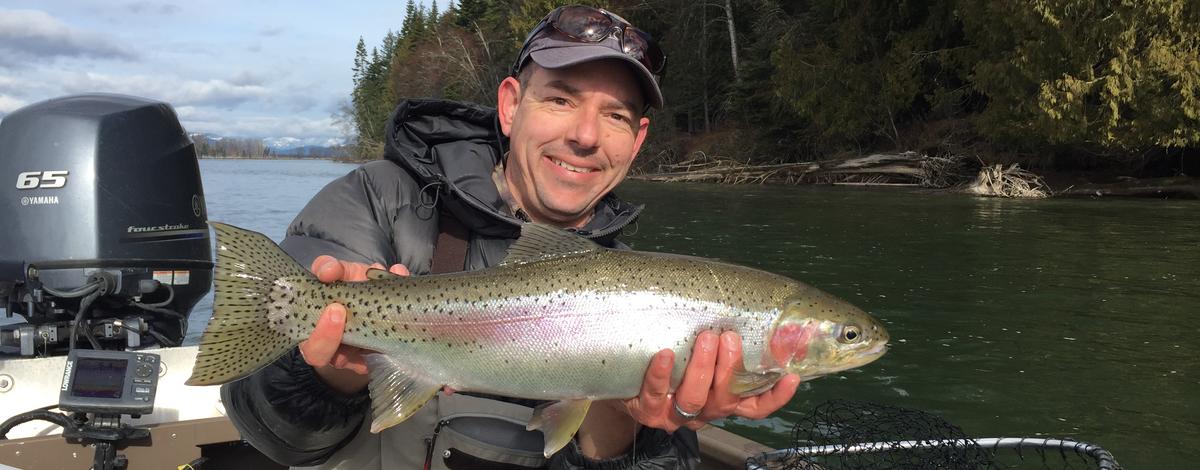 Angler with trout on Clark Fork River