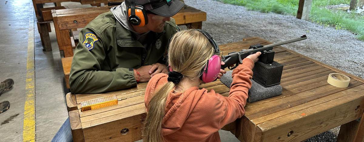 Young girl shooting a rifle at the Farragut Shooting Range Center