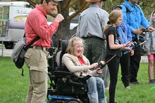 Youth group and mentors practice casting in a field